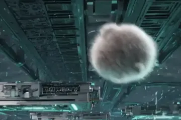 Blurry still of the dust bunny mid-air between server racks